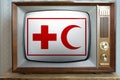 Old tube vintage TV with the flag of humanitarian organization red cross and crescent on screen, concept of eternal values Ã¢â¬â¹Ã¢â¬â¹ Royalty Free Stock Photo